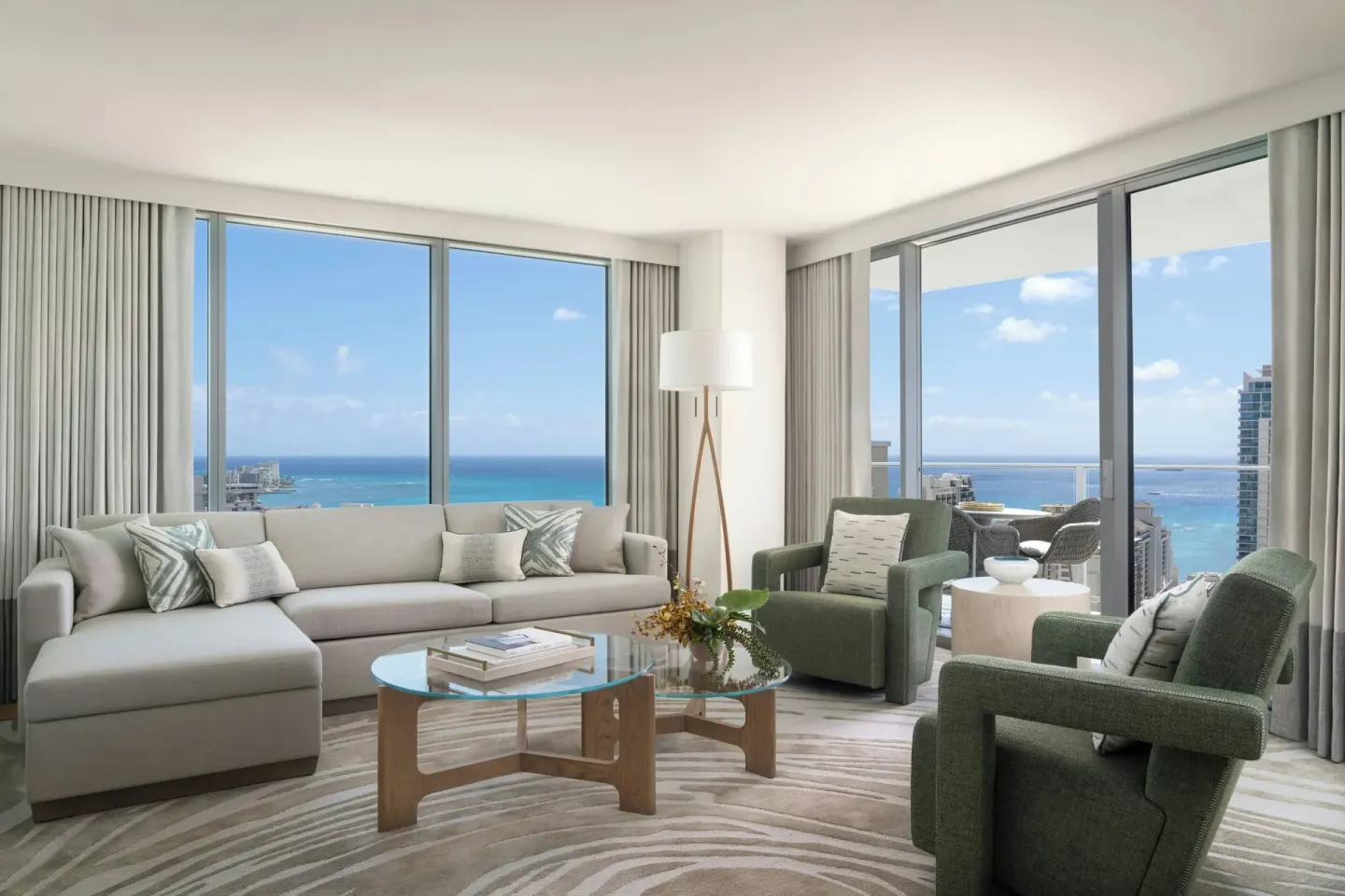 Grand Suite living room with ocean-view windows at The Ritz-Carlton Residences, Waikiki Beach.