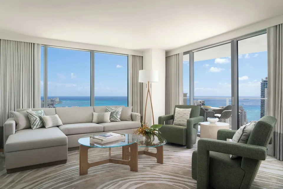 Grand Suite living room with ocean-view windows at The Ritz-Carlton Residences, Waikiki Beach.