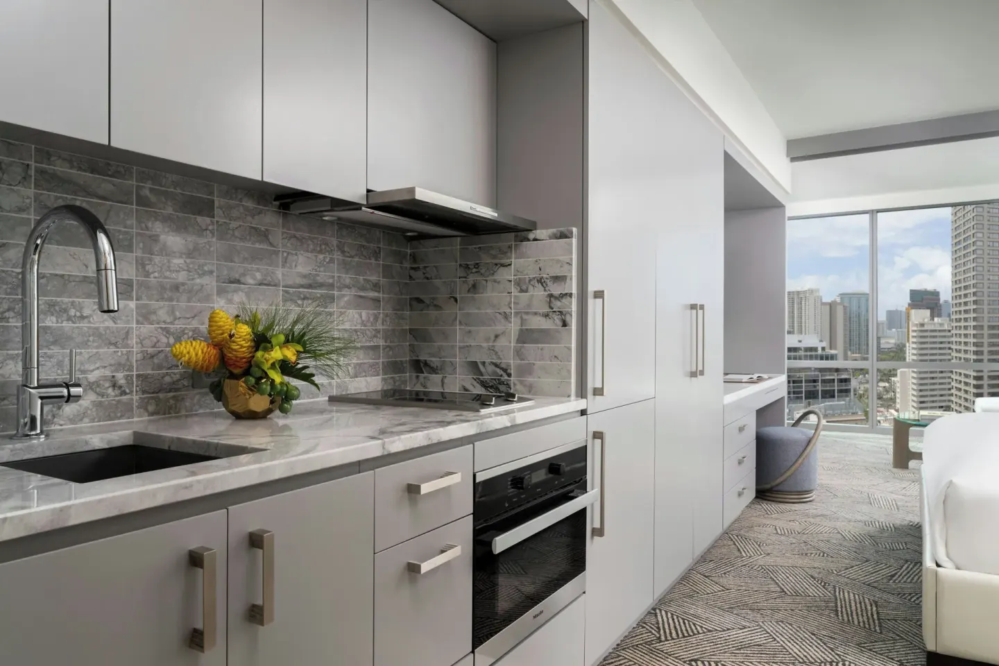 Ocean View Corner Suite kitchenette and bedroom at The Ritz-Carlton Residences, Waikiki Beach.