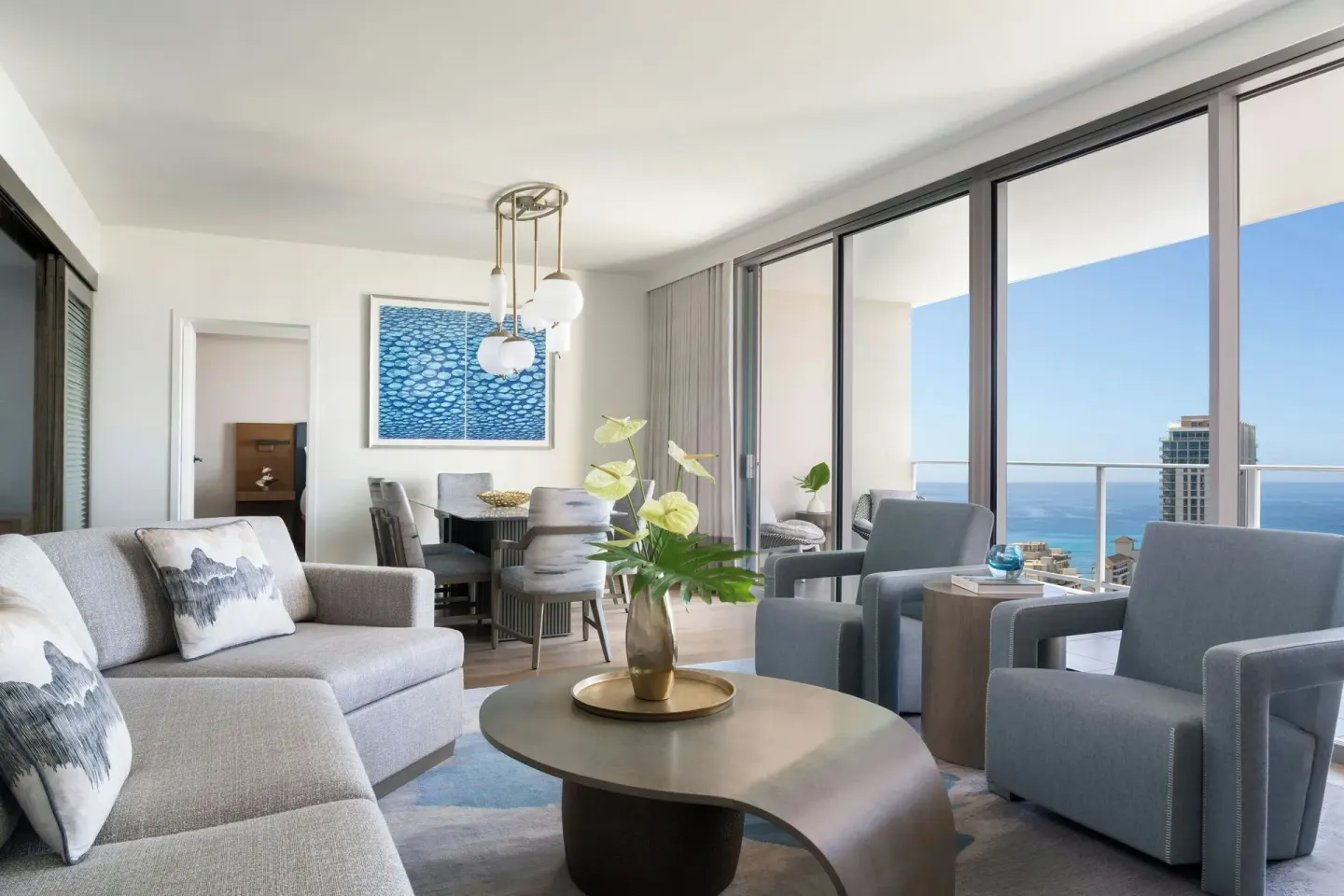 Premier Suite living room with ocean-view balcony at The Ritz-Carlton Residences, Waikiki Beach.