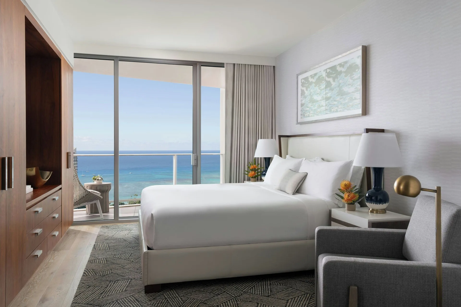 Sky Three-Bedroom Suite bedroom with balcony ocean view at The Ritz-Carlton Residences, Waikiki Beach.