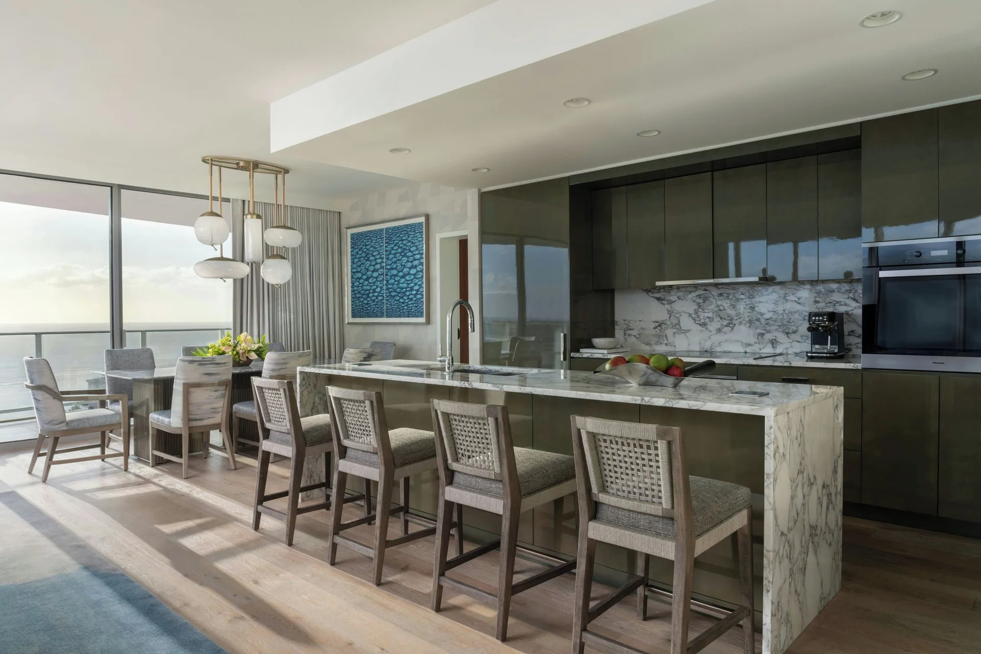 Sky Three-Bedroom Suite kitchen island and dining area at The Ritz-Carlton Residences, Waikiki Beach.