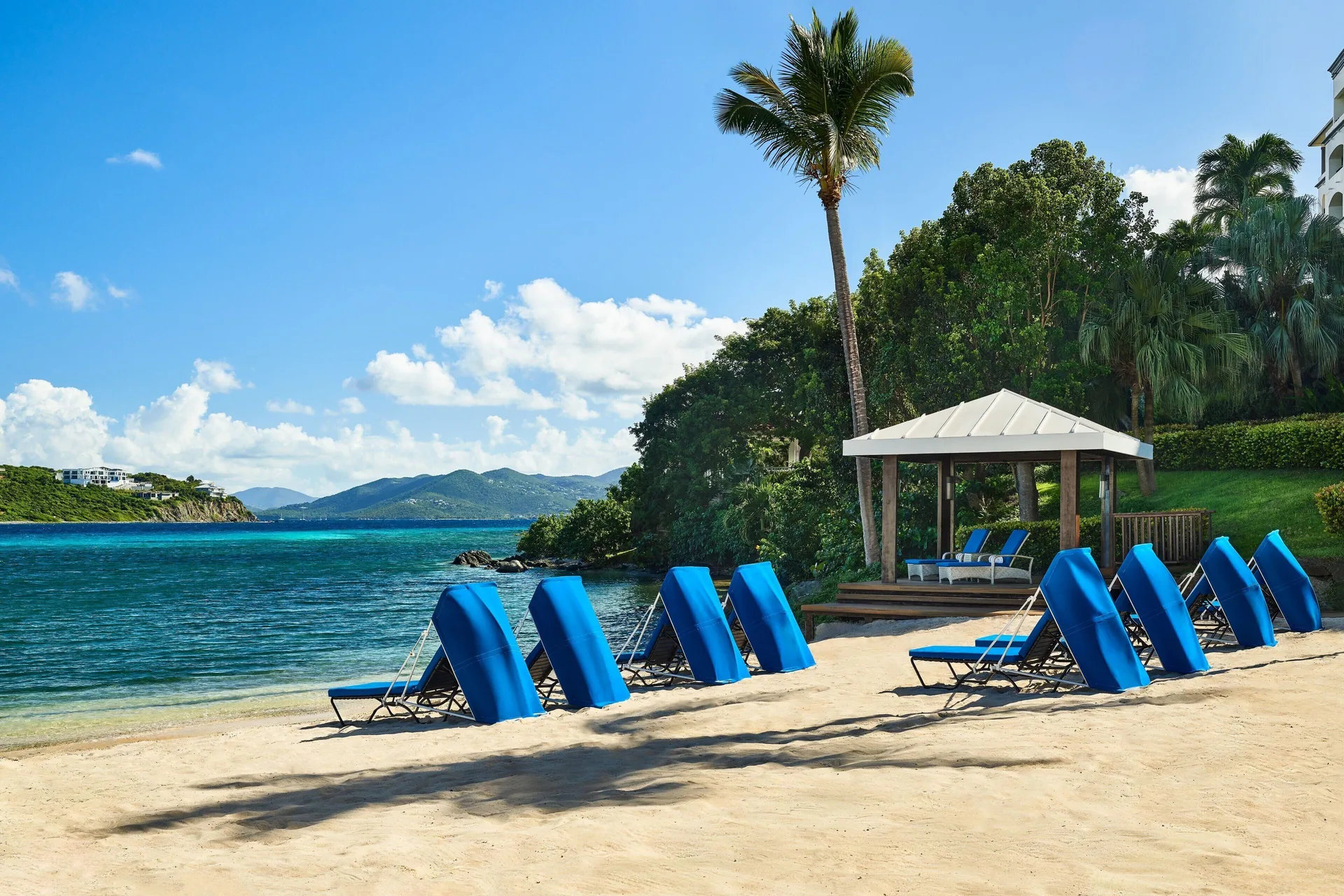 Blue lounge chairs lined along the beach at The Ritz-Carlton, St. Thomas.