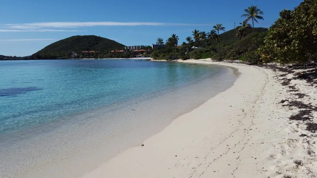 Curved sandy beach with clear blue water near The Ritz-Carlton, St. Thomas.