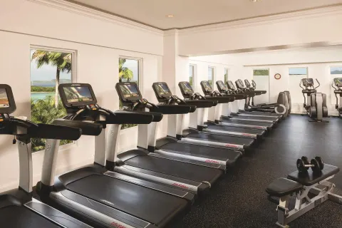 Fitness center with rows of treadmills and window views at The Ritz-Carlton, St. Thomas.