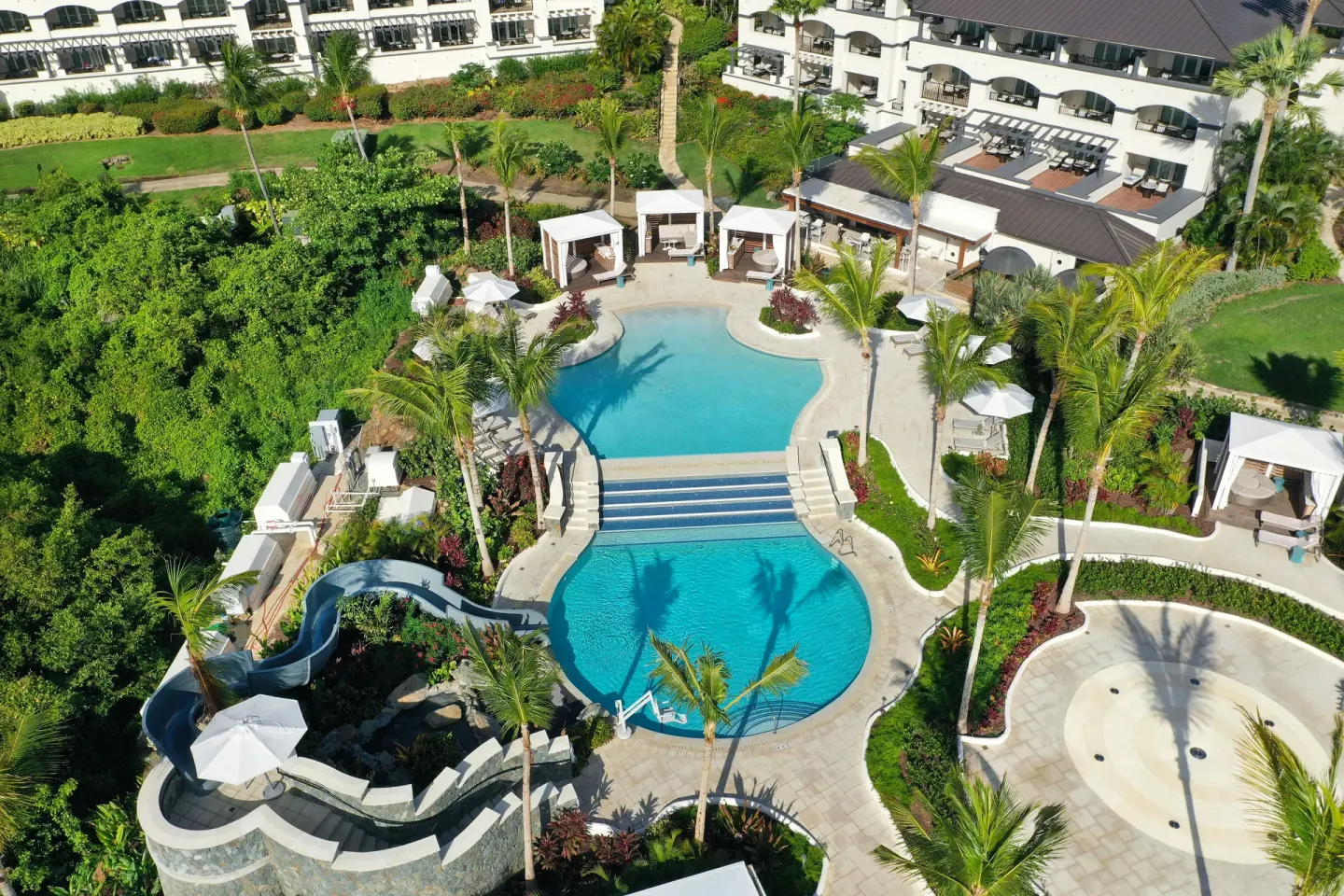 Overhead view of pools, cabanas, palms, and resort walkways at The Ritz-Carlton, St. Thomas.