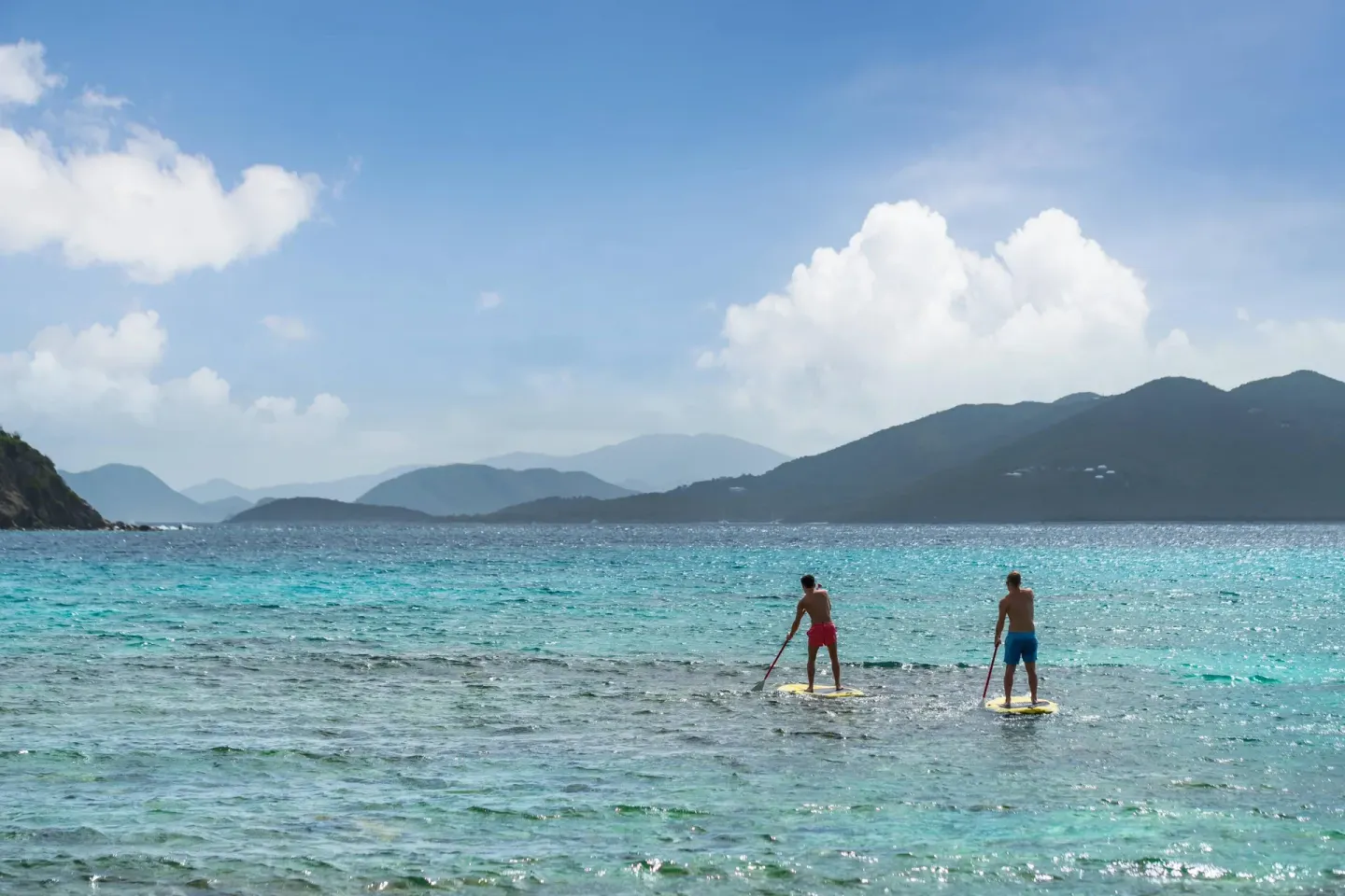 Paddleboarders on turquoise water near The Ritz-Carlton, St. Thomas.