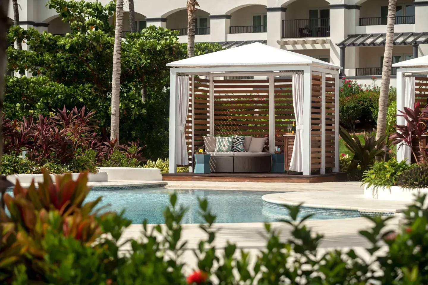 Pool cabana with sofa and tropical plants at The Ritz-Carlton, St. Thomas.
