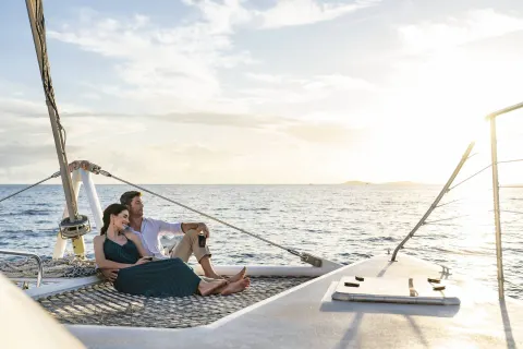 Couple relaxing on a sailboat near The Ritz-Carlton, St. Thomas.