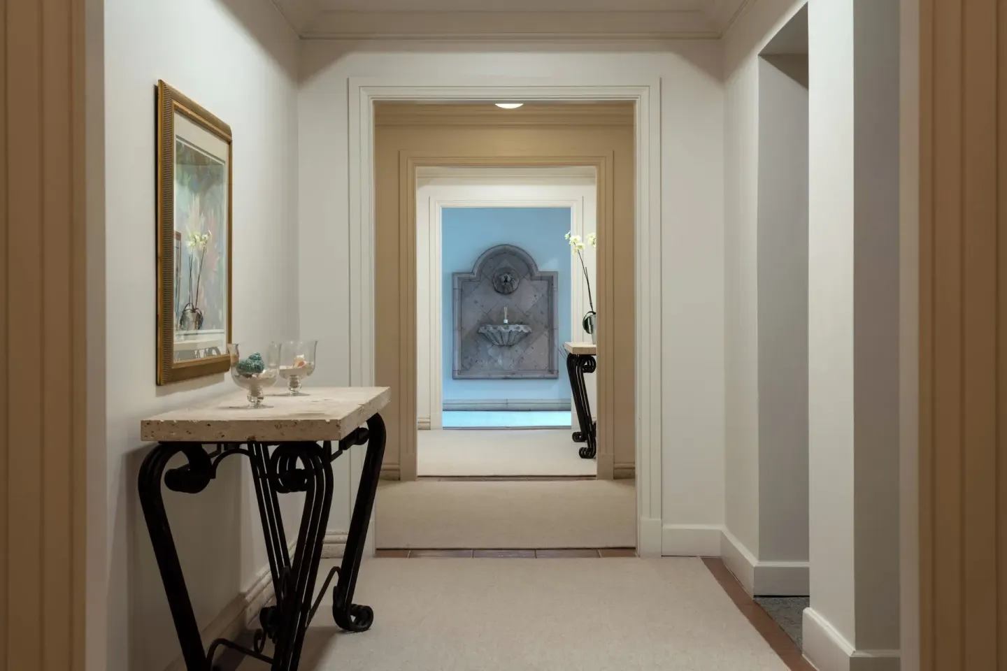 Interior spa corridor with console table and wall fountain at The Ritz-Carlton, St. Thomas.