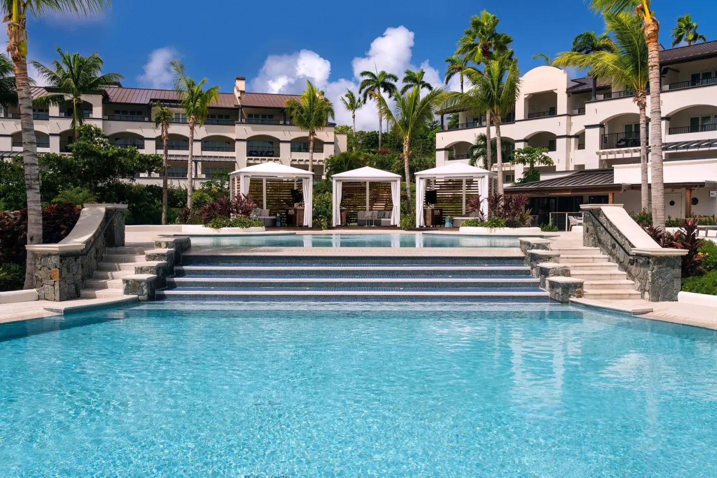 Tiered resort pool and white cabanas at The Ritz-Carlton, St. Thomas.