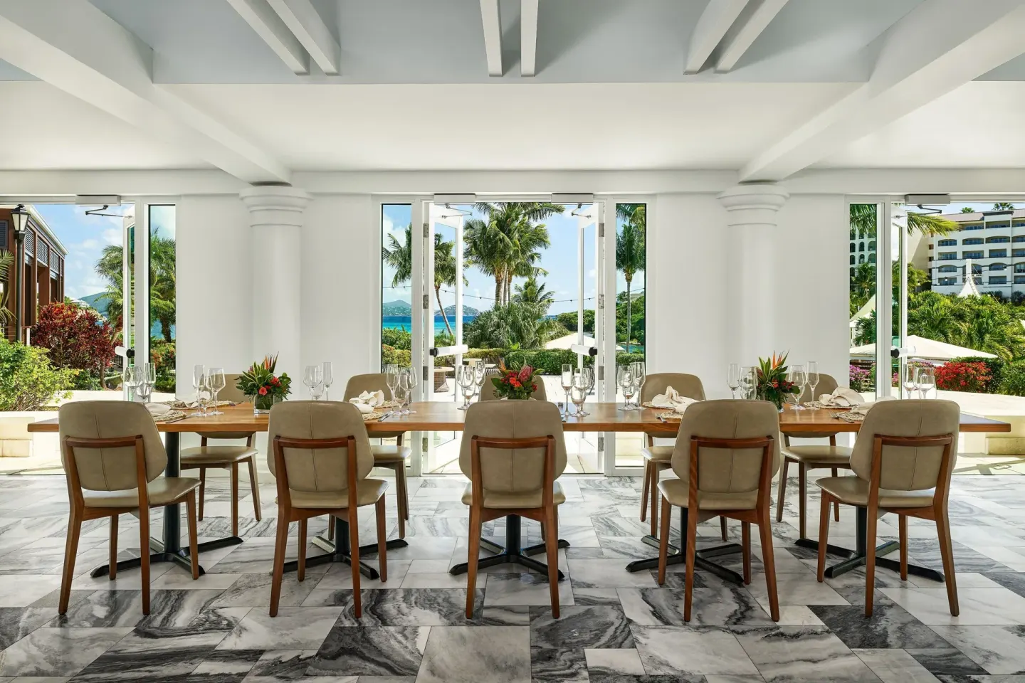 Open-air dining table with garden and ocean views at The Ritz-Carlton, St. Thomas.
