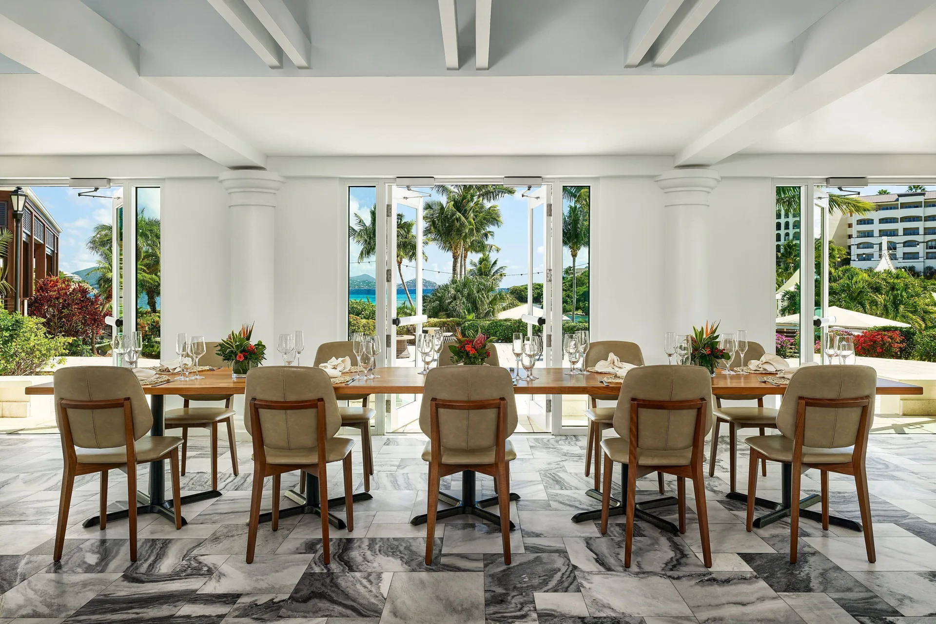 Open-air dining table with garden and ocean views at The Ritz-Carlton, St. Thomas.