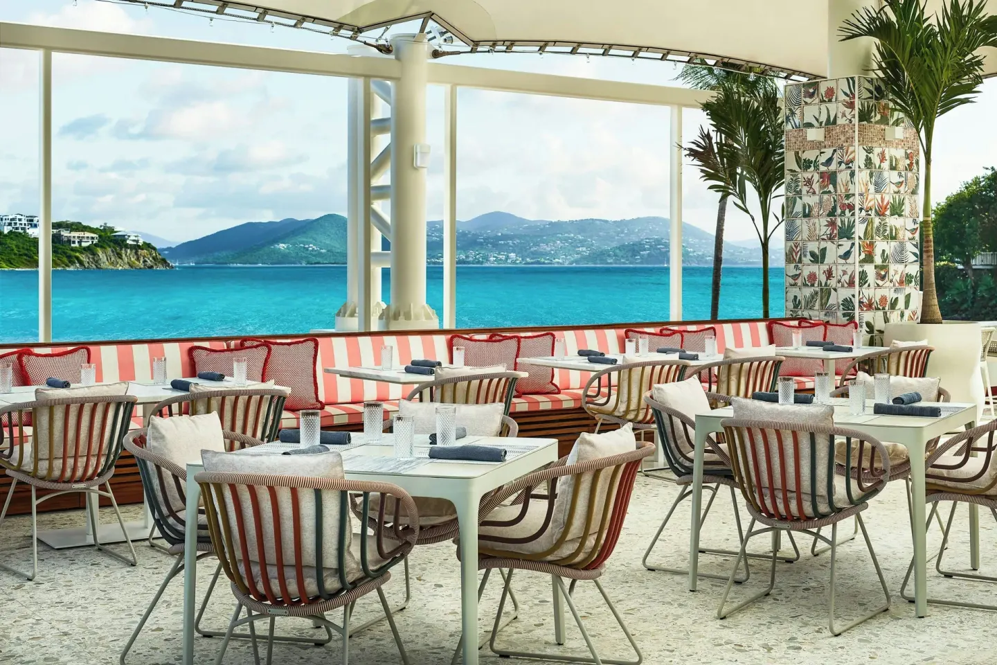 Colorful seaside dining room with striped seating at The Ritz-Carlton, St. Thomas.