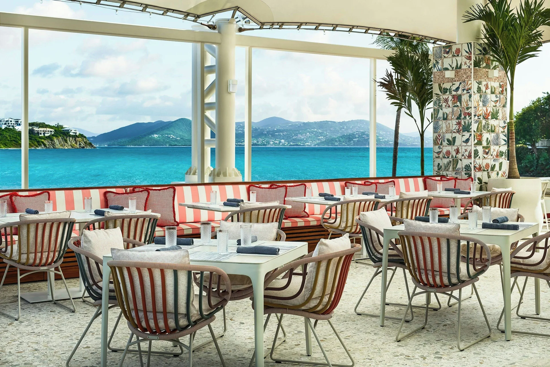 Colorful seaside dining room with striped seating at The Ritz-Carlton, St. Thomas.