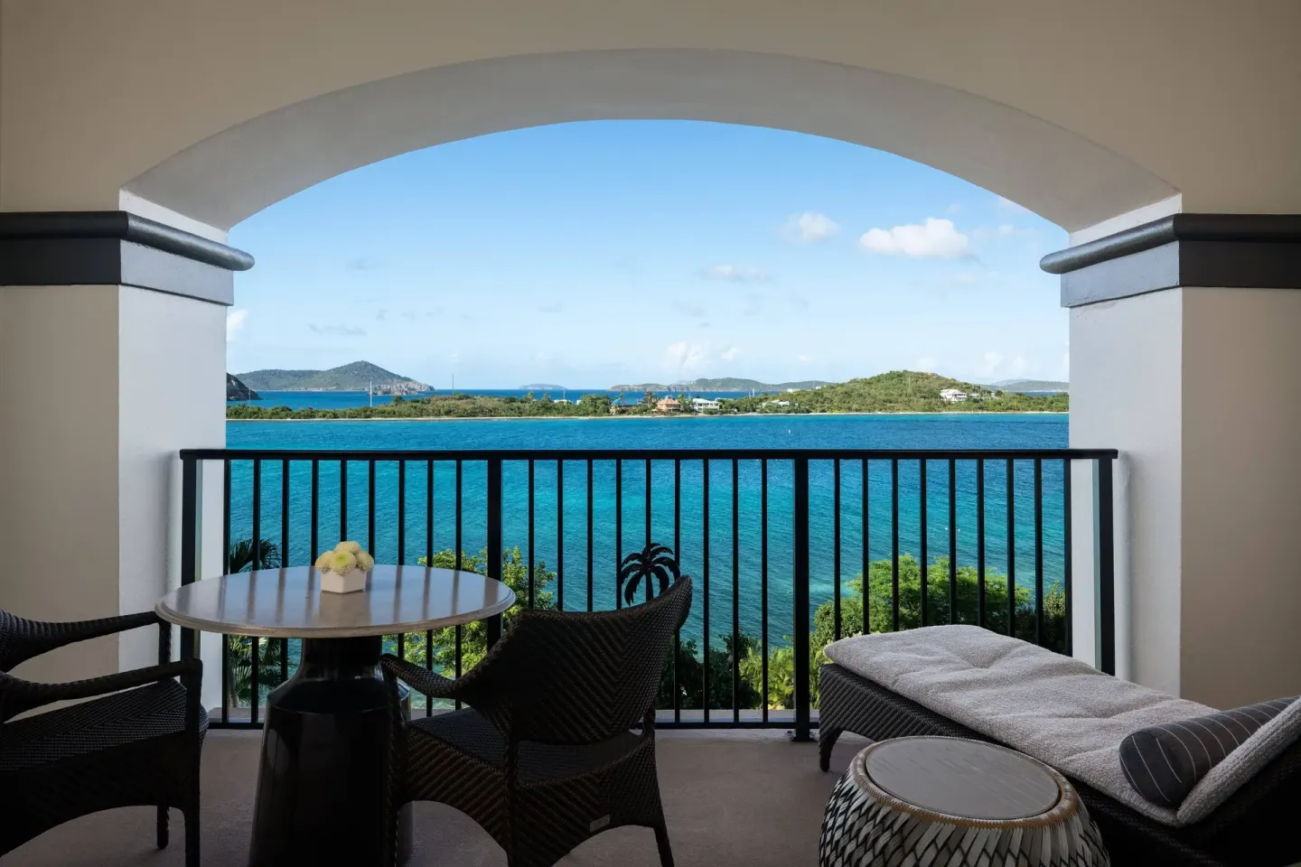 Club Oceanfront Room balcony with lounge seating and blue bay view at The Ritz-Carlton, St. Thomas.