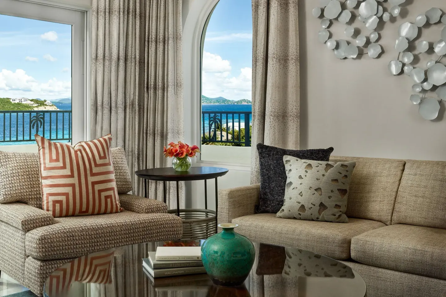 Club Oceanfront Suite sitting area with ocean-view windows at The Ritz-Carlton, St. Thomas.