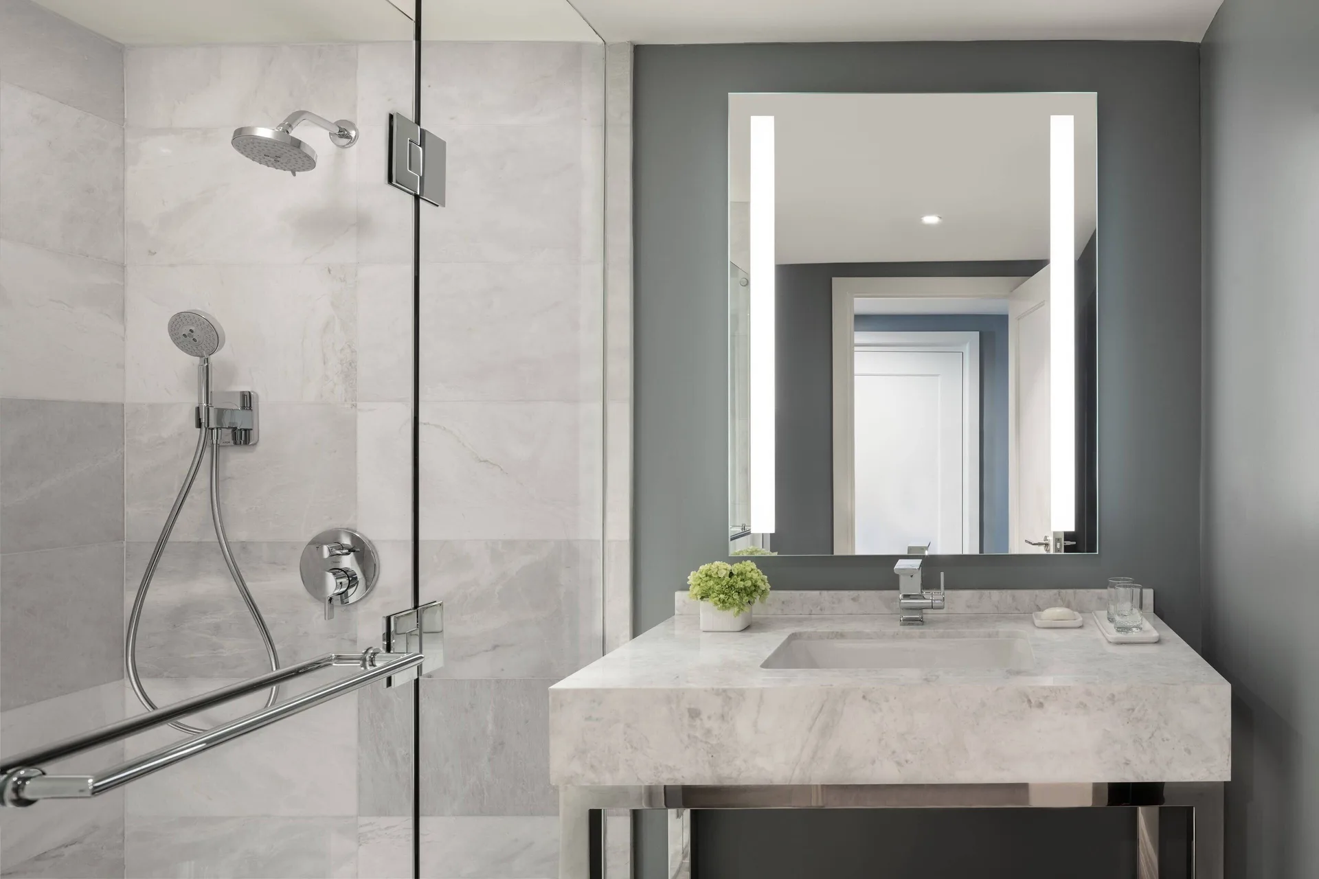Executive Suite bathroom at The Ritz-Carlton, St. Thomas with shower, vanity and lit mirror.