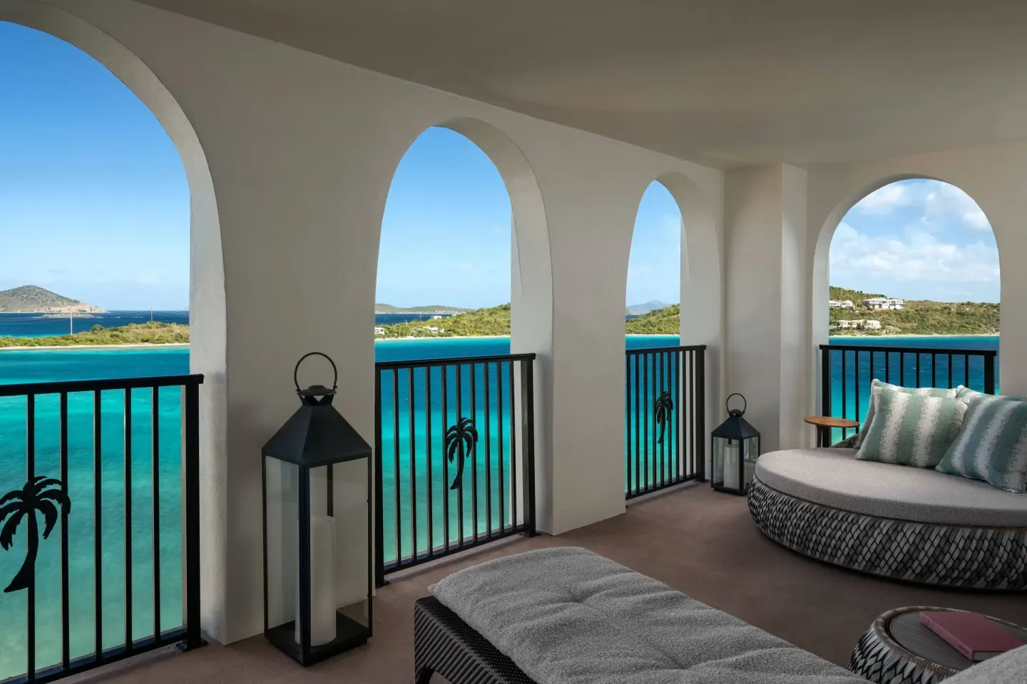 Presidential 1 Bedroom Suite arched balcony at The Ritz-Carlton, St. Thomas above turquoise water.