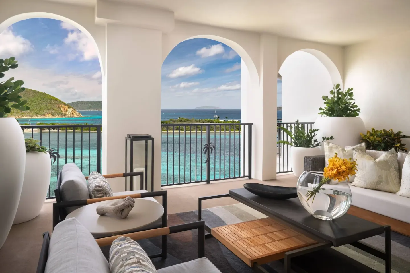 Presidential 1 Bedroom Suite balcony lounge at The Ritz-Carlton, St. Thomas overlooking turquoise water.