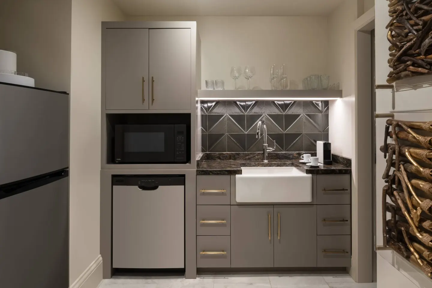 Presidential 1 Bedroom Suite wet bar at The Ritz-Carlton, St. Thomas with sink, refrigerator, and tile.