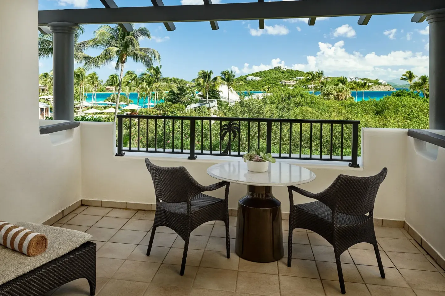 Furnished Resort View Room balcony with tropical views at The Ritz-Carlton, St. Thomas.