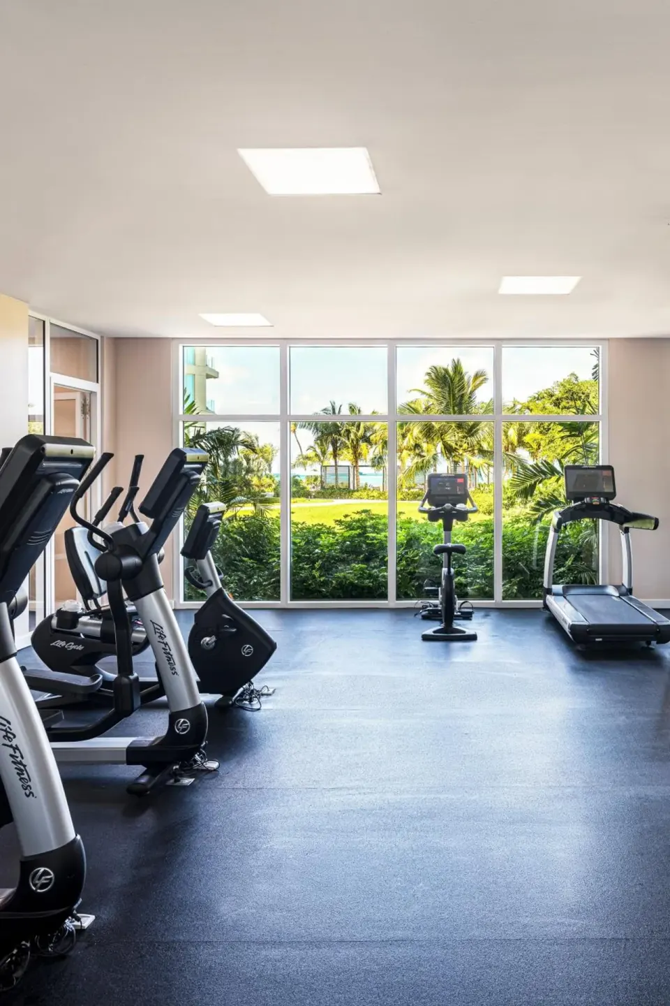 Fitness center cardio machines face garden windows at The Ritz-Carlton, Turks & Caicos.