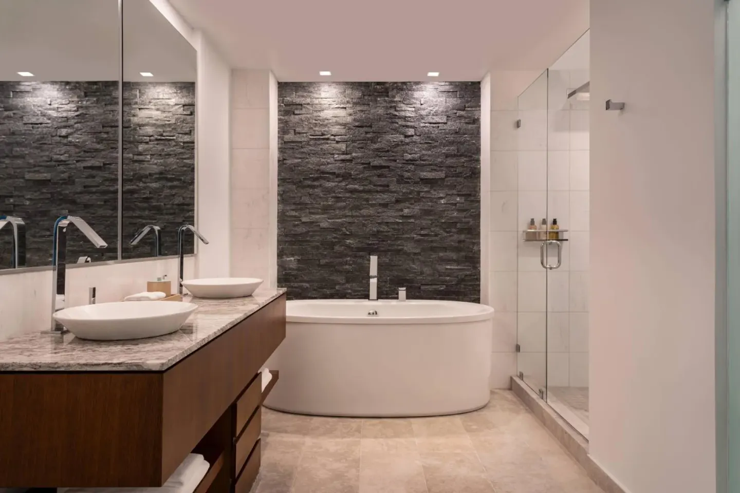 Guest bathroom with soaking tub and glass shower at The Ritz-Carlton, Turks & Caicos.