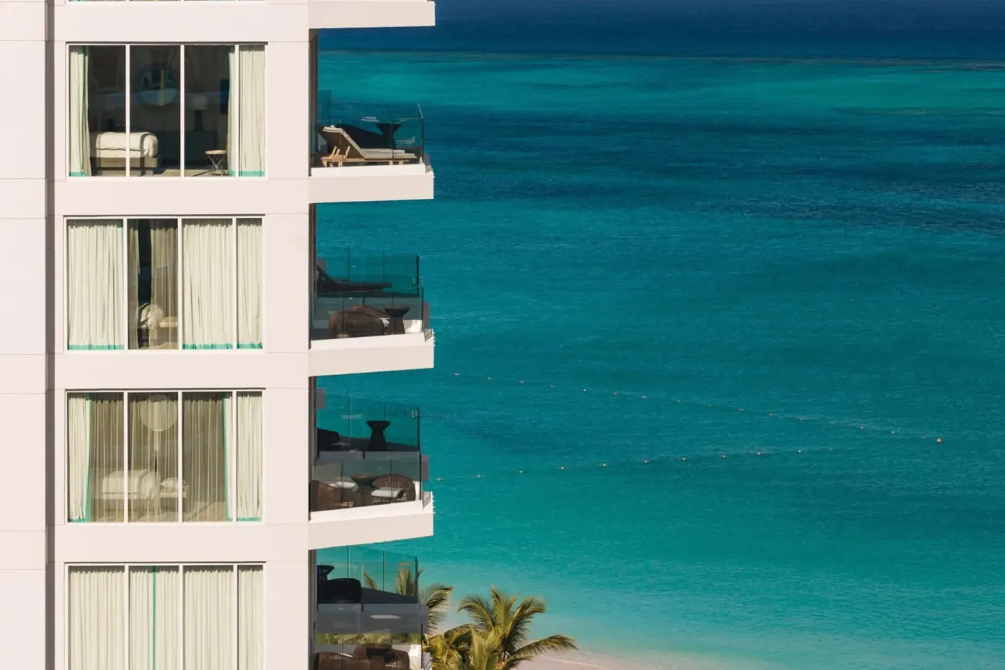 Balconies at The Ritz-Carlton, Turks & Caicos overlooking vivid turquoise ocean water.