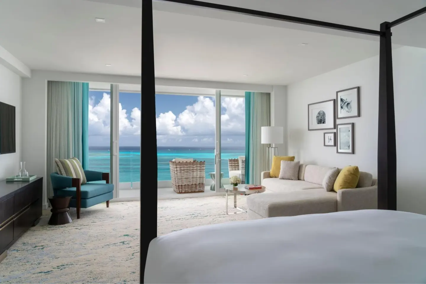 Ocean view guest room with four-poster bed at The Ritz-Carlton, Turks & Caicos.