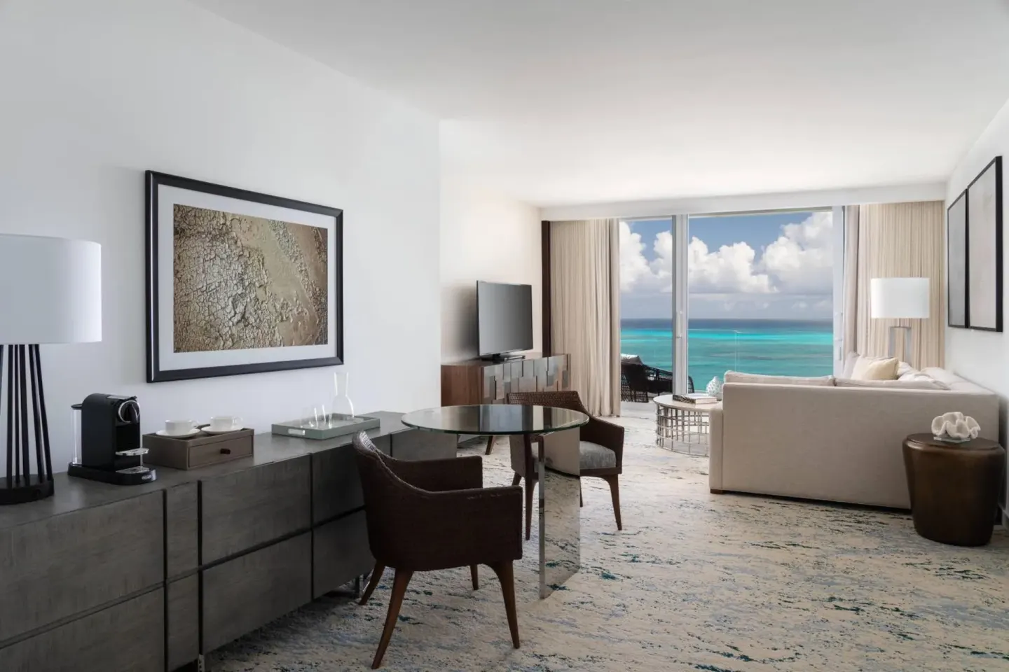 Ocean-view suite living area with dining table at The Ritz-Carlton, Turks & Caicos.