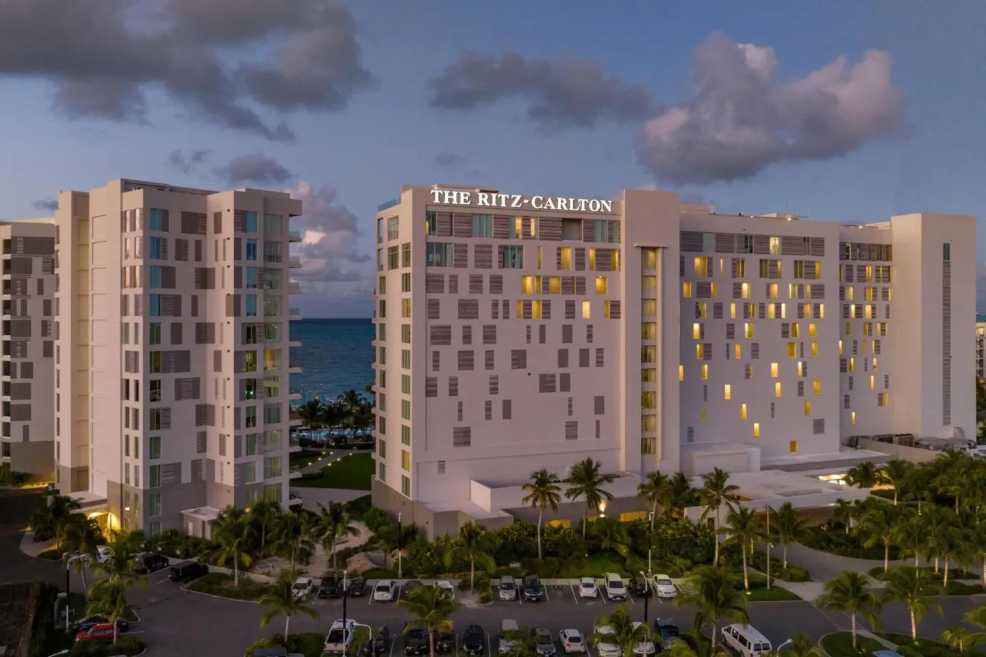 Exterior towers with illuminated windows at dusk at The Ritz-Carlton, Turks & Caicos.