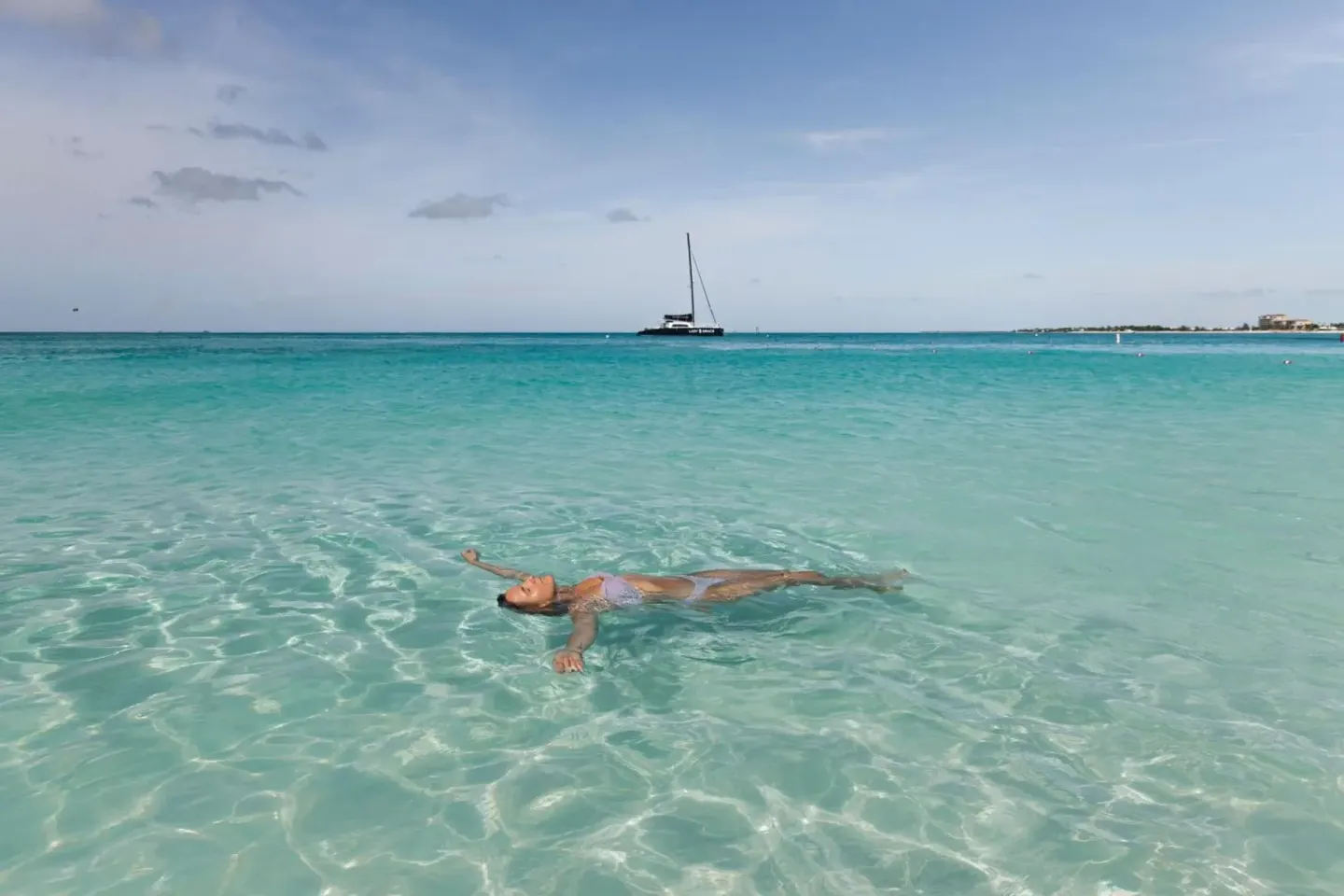 A swimmer floats in clear turquoise water near The Ritz-Carlton, Turks & Caicos.