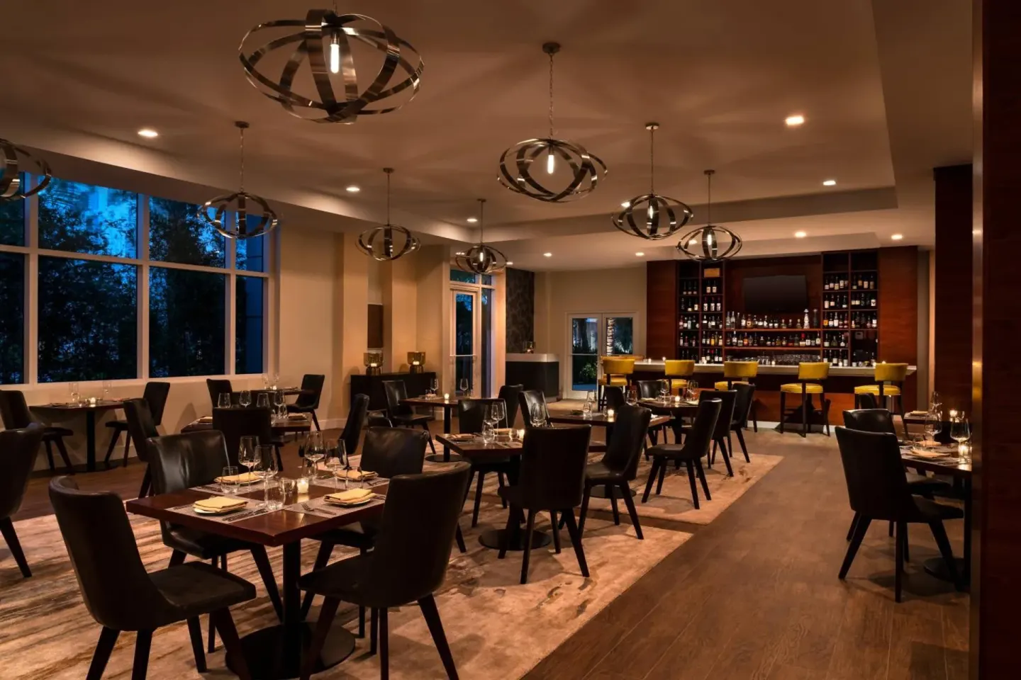 Dimly lit restaurant dining room and bar at The Ritz-Carlton, Turks & Caicos.