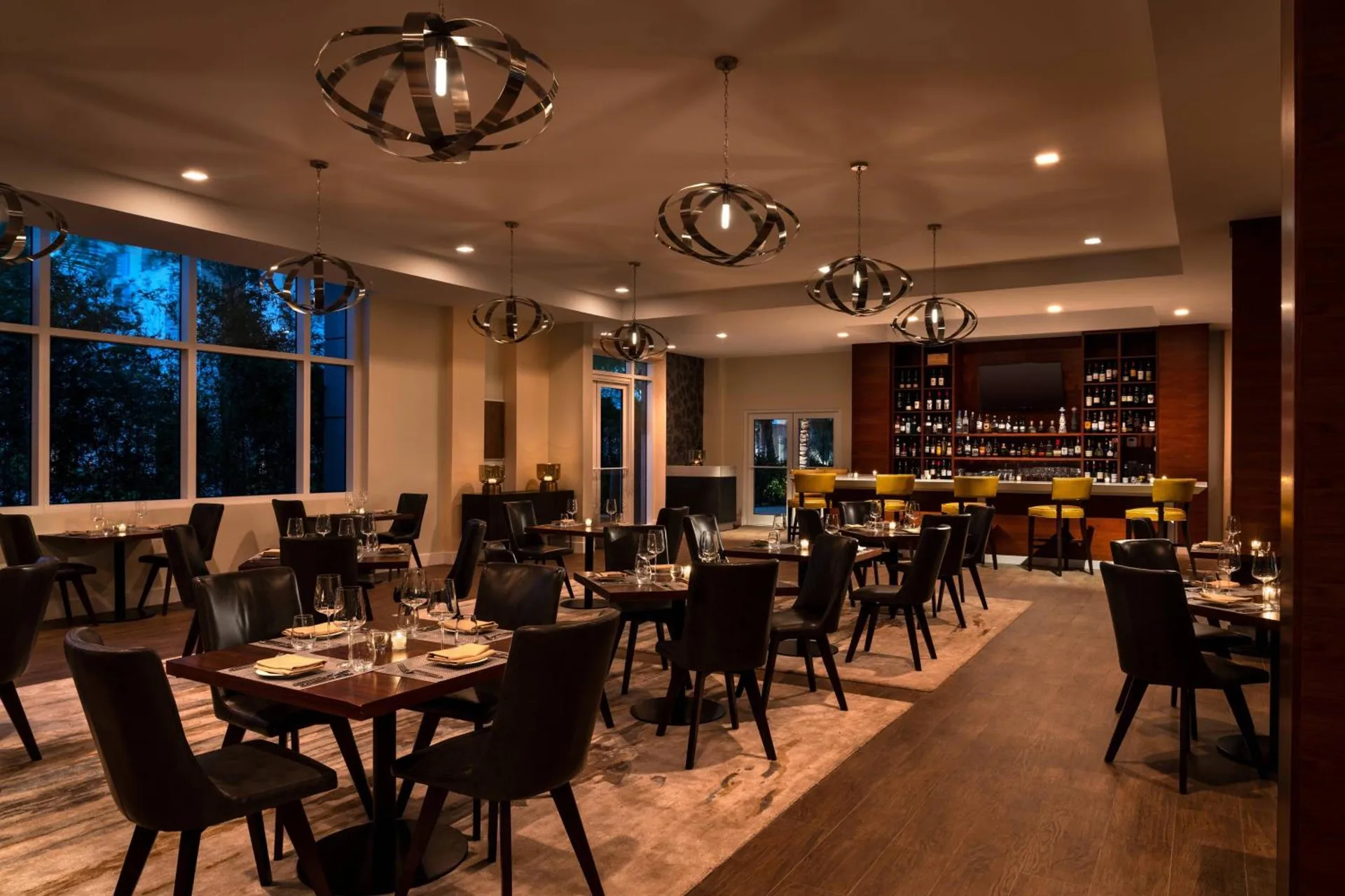 Dimly lit restaurant dining room and bar at The Ritz-Carlton, Turks & Caicos.