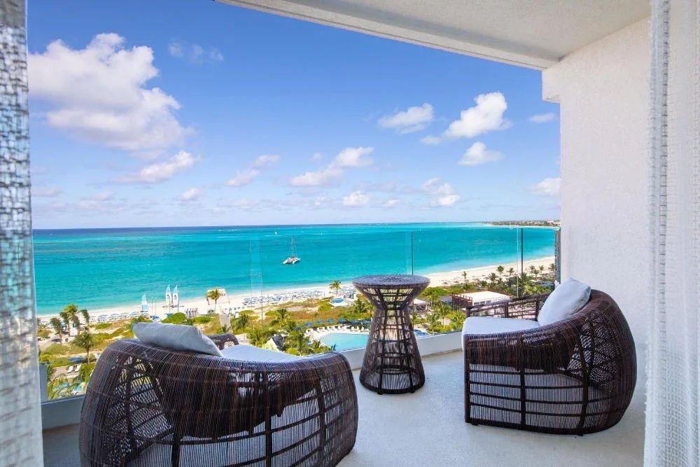 Balcony seating with turquoise ocean view at The Ritz-Carlton, Turks & Caicos.