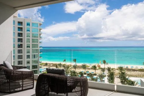 Oceanfront balcony with wicker seating and sea view at The Ritz-Carlton, Turks & Caicos.