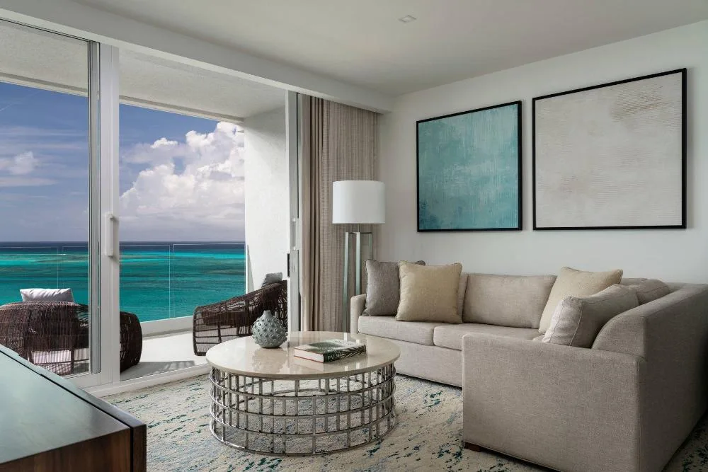 Oceanfront suite living room with balcony view at The Ritz-Carlton, Turks & Caicos.