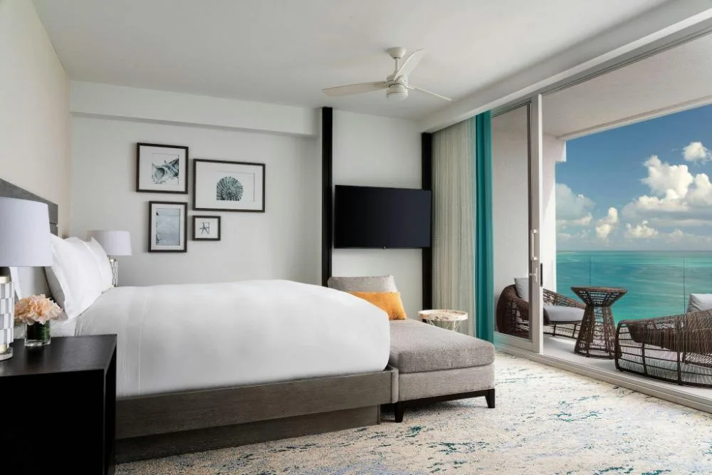 Oceanfront junior suite bedroom with balcony at The Ritz-Carlton, Turks & Caicos.