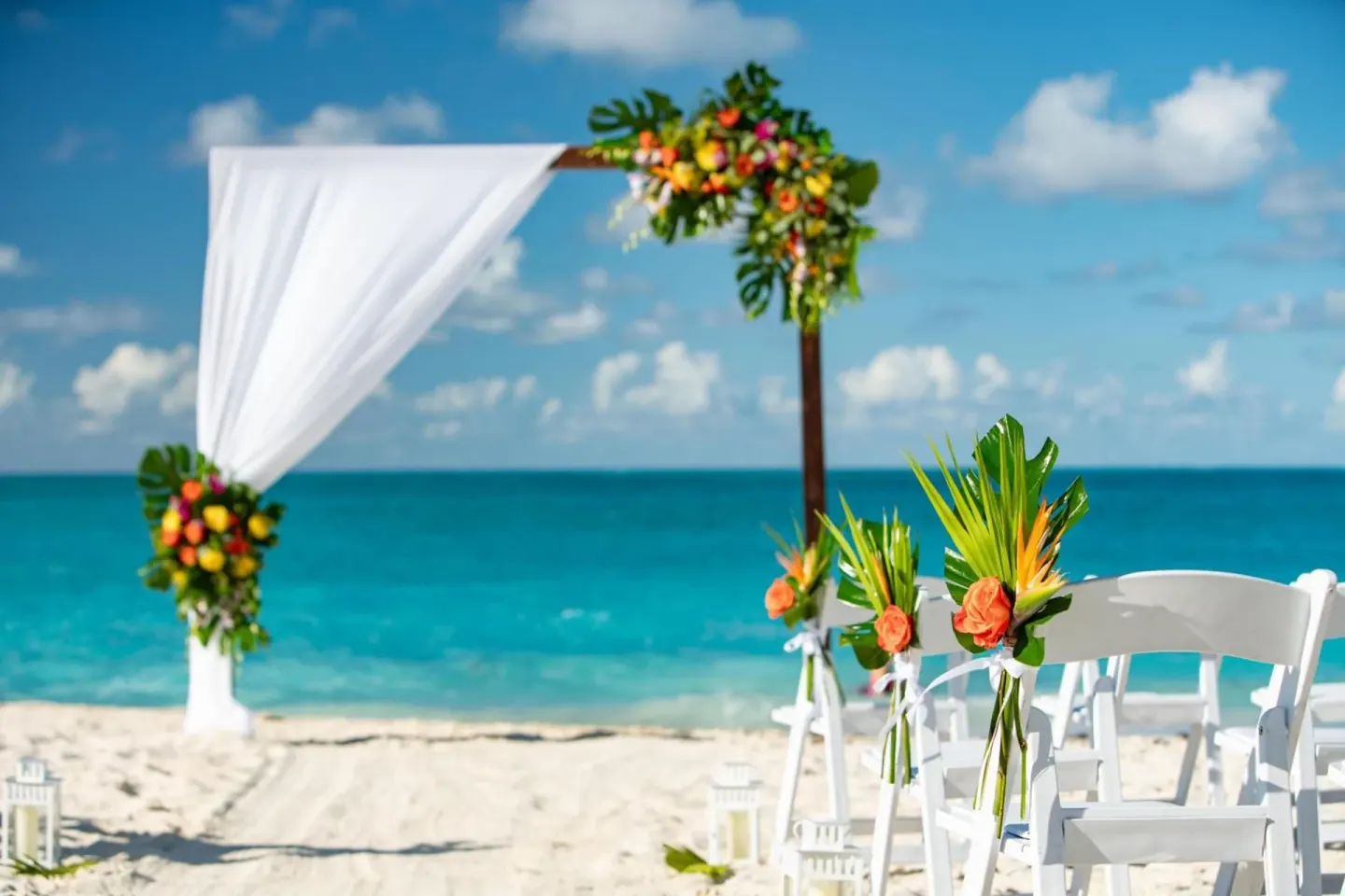 Beach wedding arch with tropical flowers at The Ritz-Carlton, Turks & Caicos.
