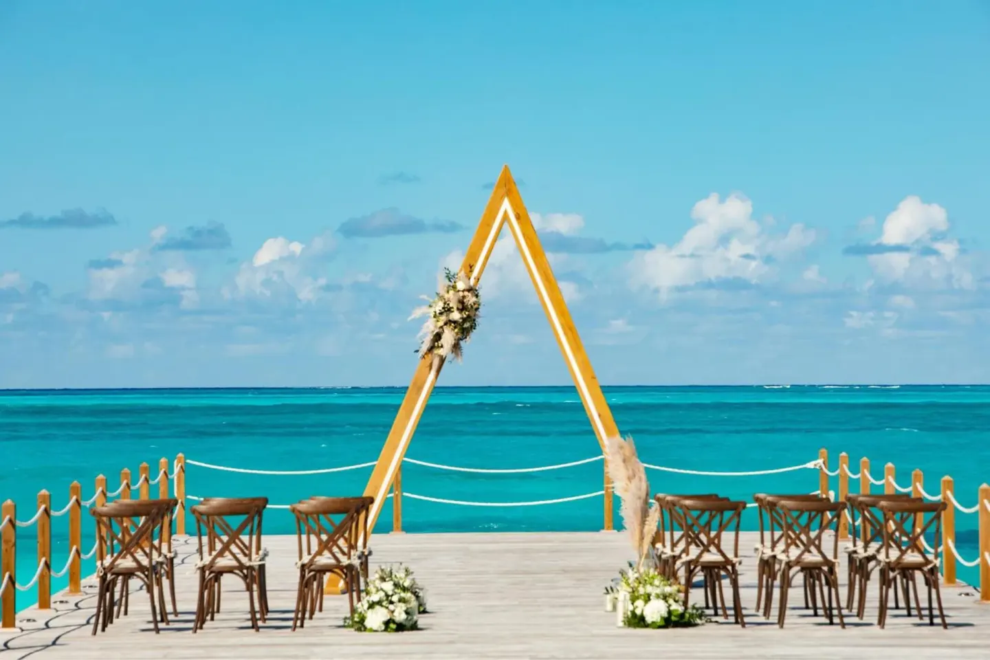 Beach wedding ceremony setup over turquoise water at The Ritz-Carlton, Turks & Caicos.
