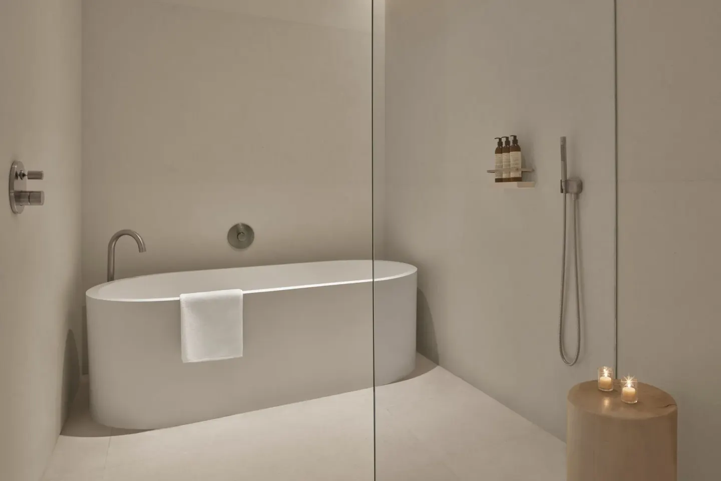 Minimal bathroom at The Riviera Maya EDITION At Kanai with soaking tub and glass shower.