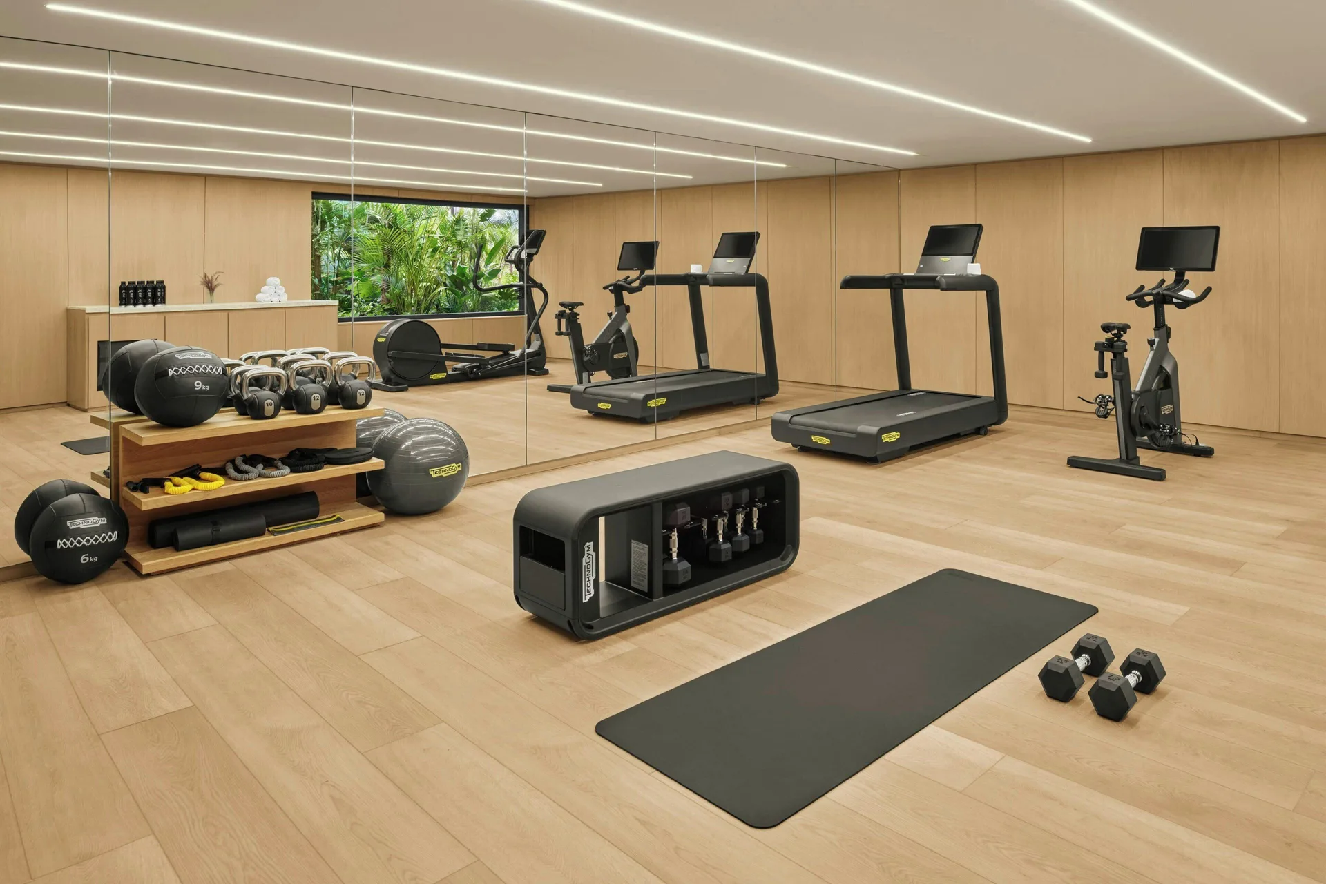 Fitness room with treadmills, weights and exercise mat at The Riviera Maya EDITION At Kanai.