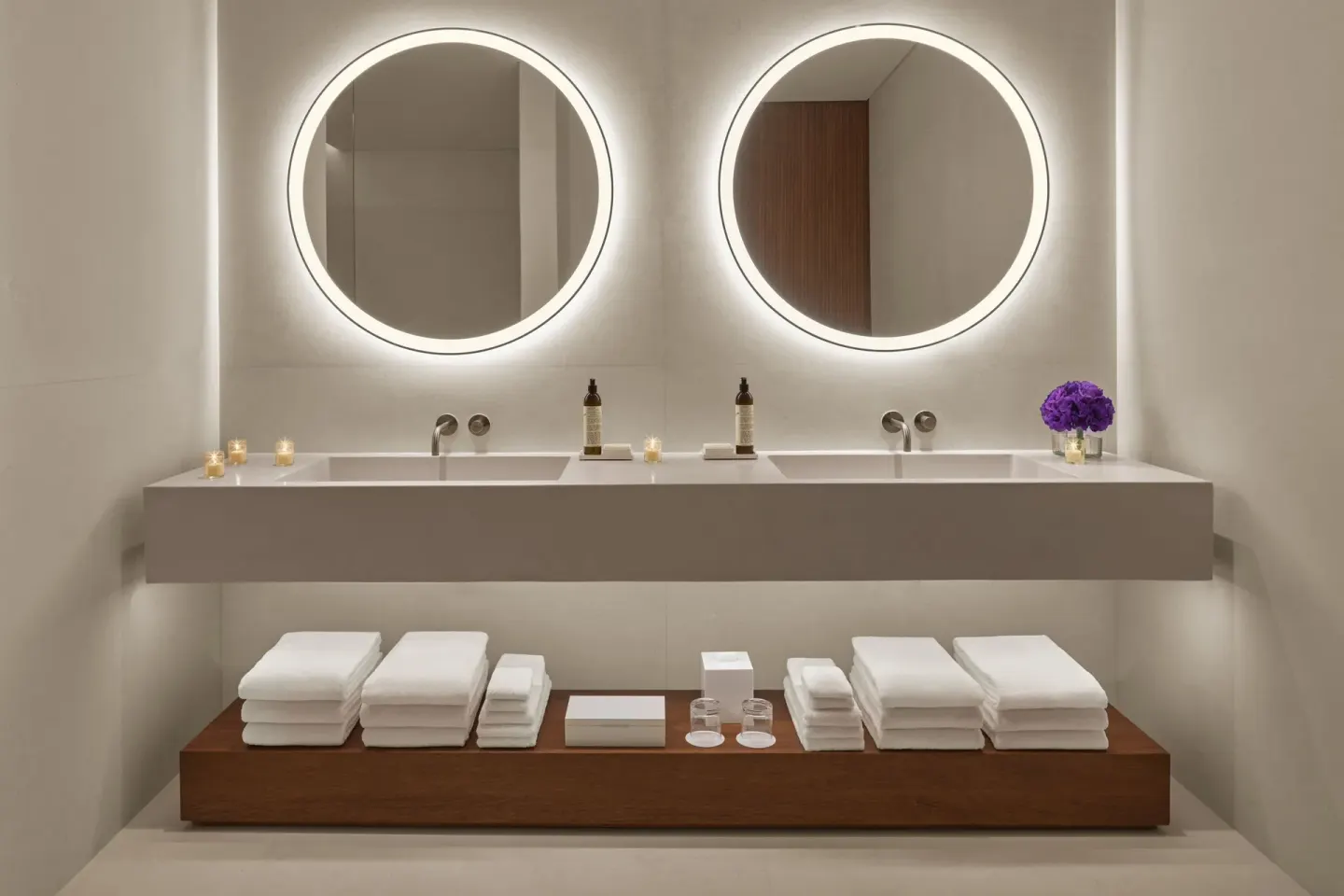 Double vanity with round mirrors and towels at The Riviera Maya EDITION At Kanai.
