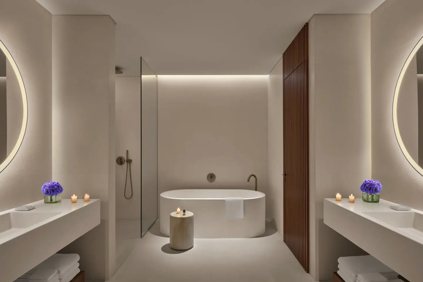 Symmetrical guest bathroom with tub and dual vanities at The Riviera Maya EDITION At Kanai.
