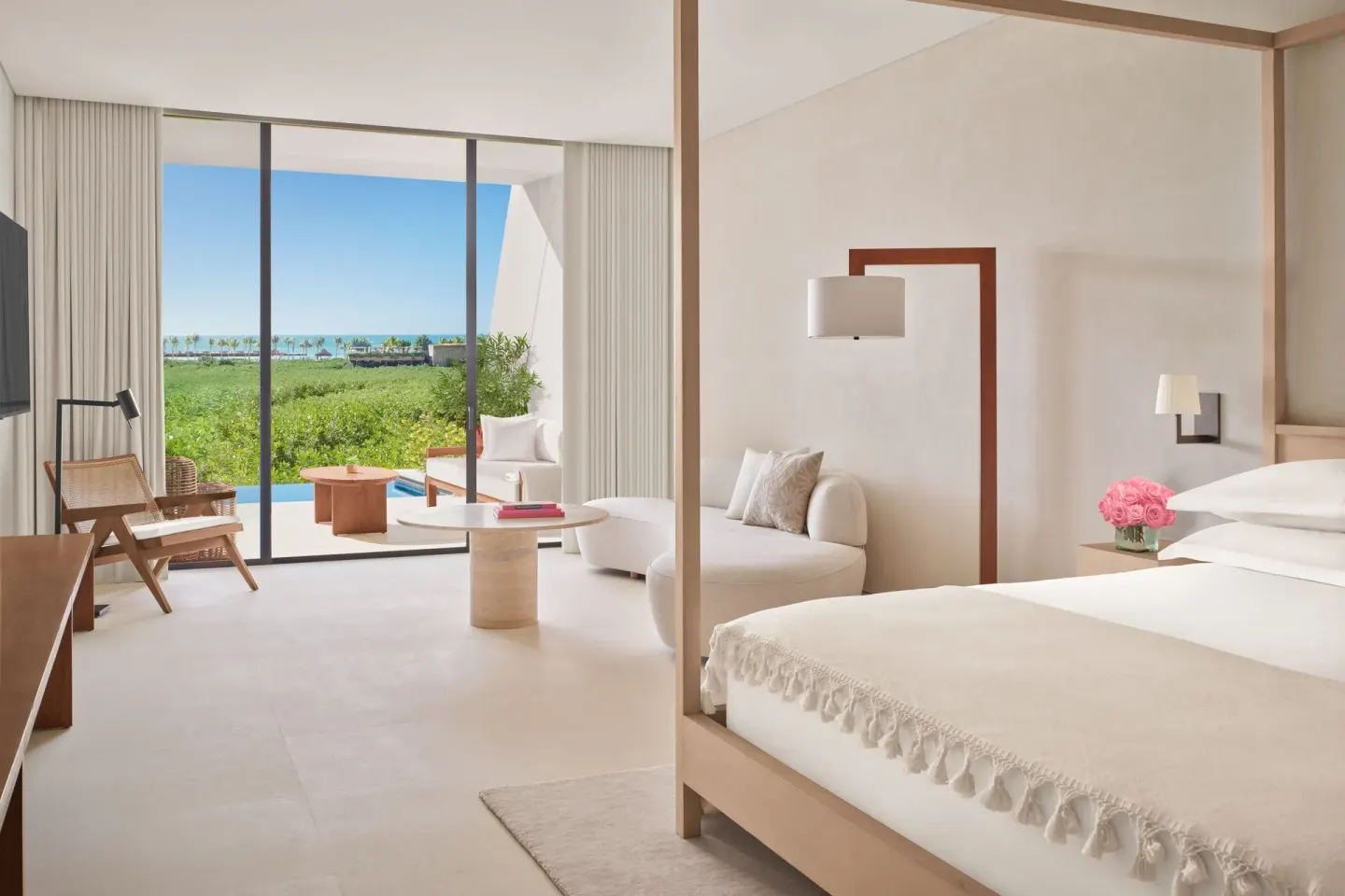 King-bed guest room with terrace and ocean glimpse at The Riviera Maya EDITION At Kanai.