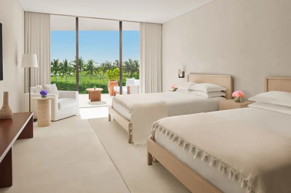 Two-bed guest room with terrace and palm views at The Riviera Maya EDITION At Kanai.