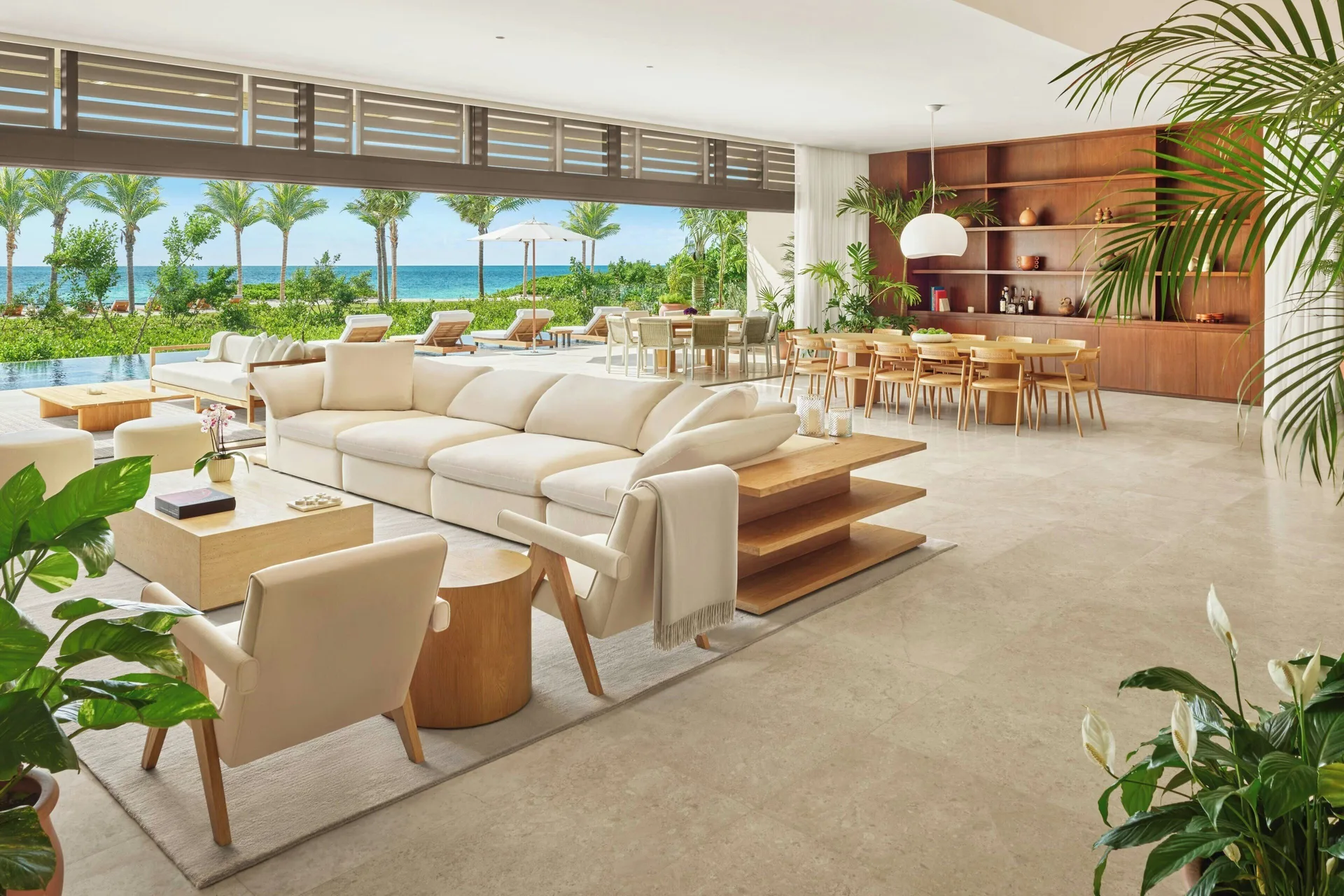 Indoor-outdoor lounge with pool and ocean views at The Riviera Maya EDITION At Kanai.