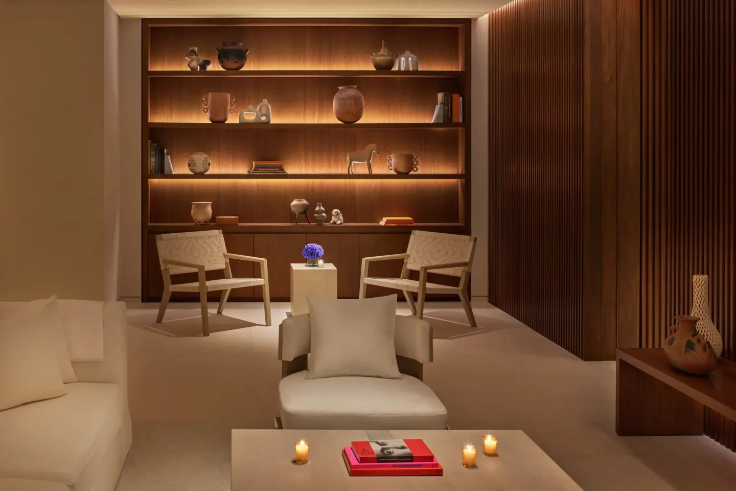Lounge seating with illuminated shelves at The Riviera Maya EDITION At Kanai.