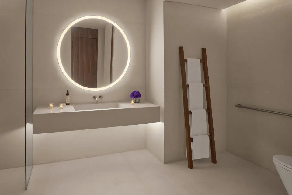 Minimal bathroom with round lit mirror at The Riviera Maya EDITION At Kanai.